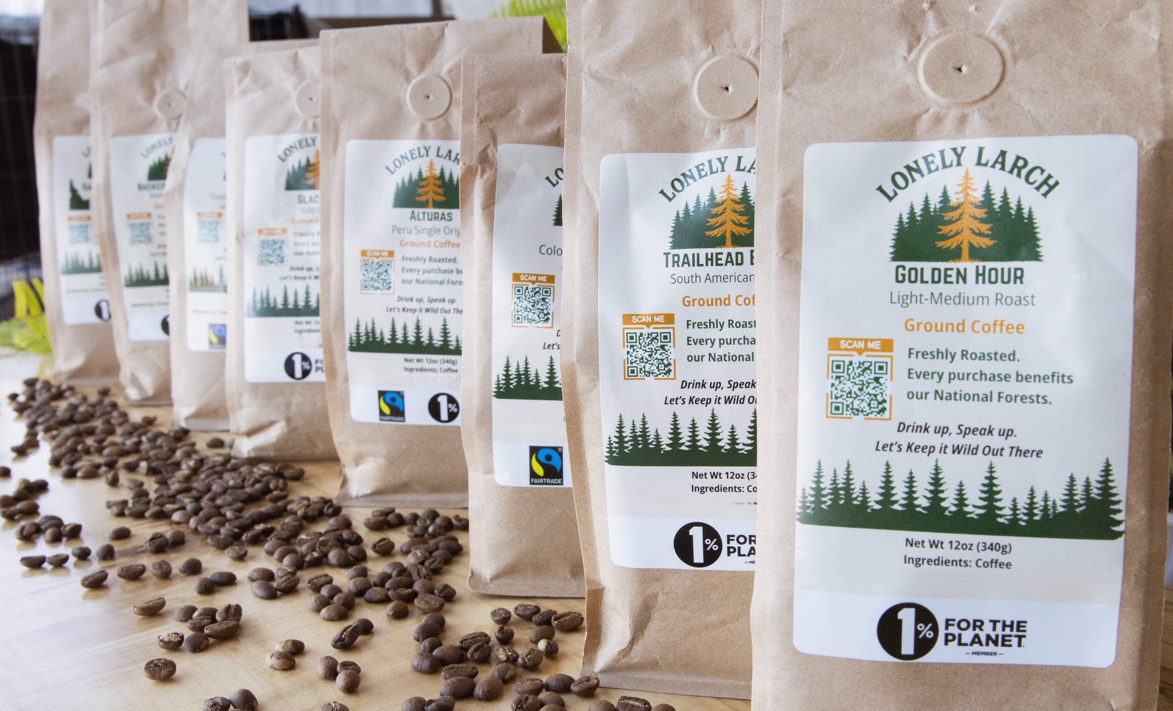 Coffee bags with visible branding and coffee beans on a wooden surface